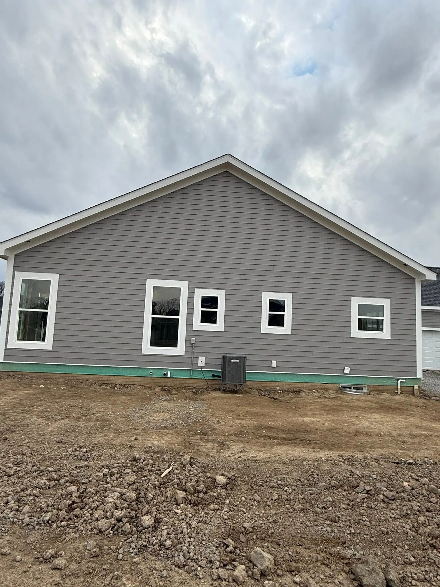 Gray siding exterior painting on a new construction home