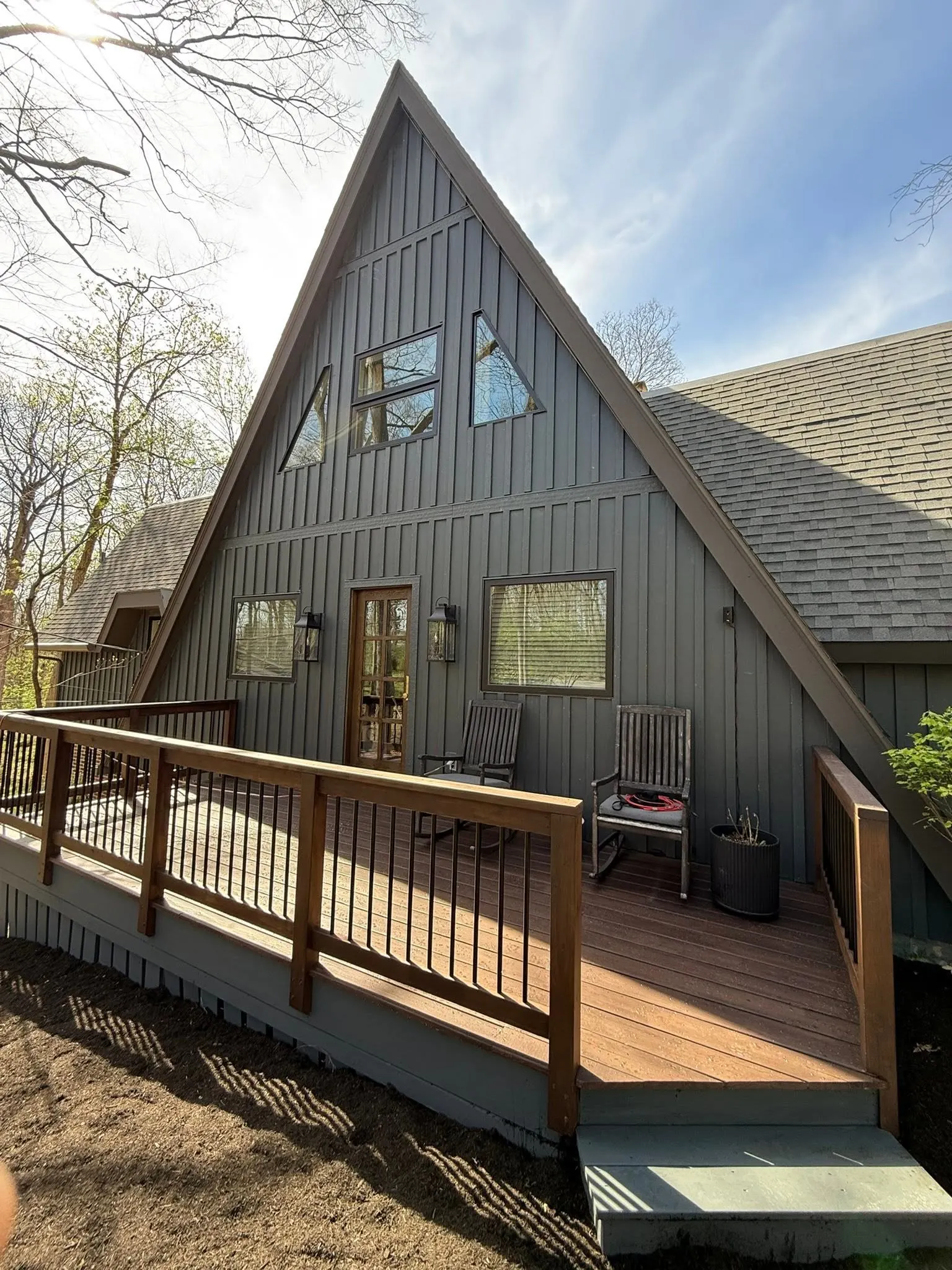 Exterior painting and deck finishing on an A-frame home